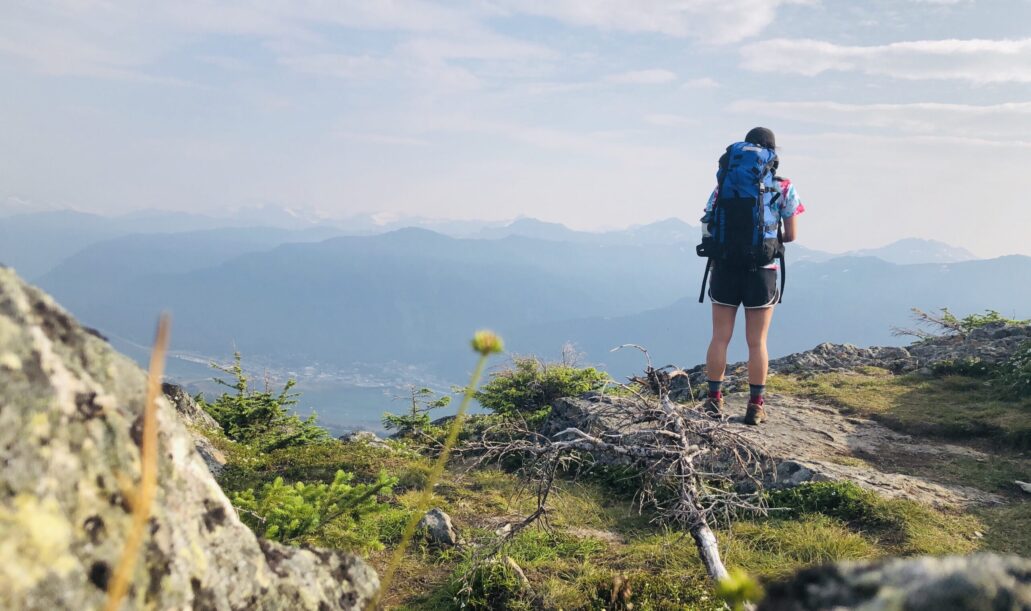 hiker-backpacker-looking-out-at-mountain-top-summe-2024-05-27-00-26-37-utc hiker-backpacker-looking-out-at-mountain-top-summe-2024-05-27-00-26-37-utc